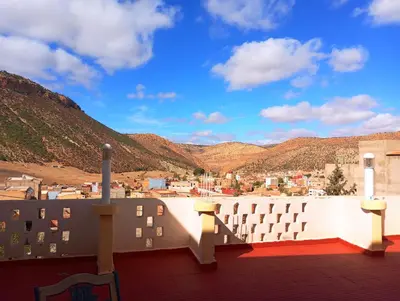 a balcony with a view of a city and mountains at Boulemane guest house in Boulmane