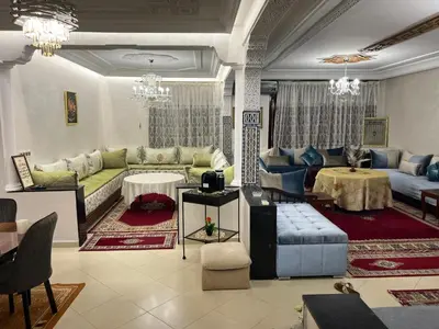 a living room with a couch and a table at Appartement Jardin Prestige - Fes Centre Ville in Fès