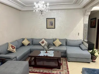 a living room with a couch and a table at Appartement Jardin Prestige - Fes Centre Ville in Fès