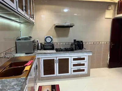 a kitchen with a sink and a counter top at Appartement Jardin Prestige - Fes Centre Ville in Fès