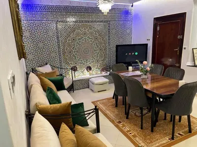 a living room with a couch and a table at Appartement Jardin Prestige - Fes Centre Ville in Fès