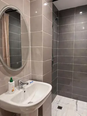 a bathroom with a sink and a mirror at Cozy Apartment 5 min From The City Center in Fès