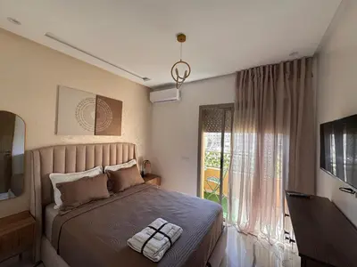 a bedroom with a large bed and a window at Cozy Apartment 5 min From The City Center in Fès