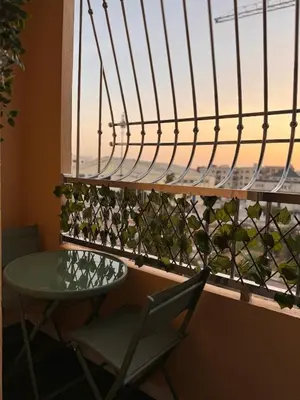 a table and chair in front of a window with a view at Cozy Apartment 5 min From The City Center in Fès