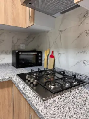 a stove top oven sitting on a counter in a kitchen at Cozy Apartment 5 min From The City Center in Fès