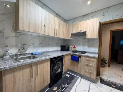 a kitchen with a sink and a washing machine at Cozy Apartment 5 min From The City Center in Fès
