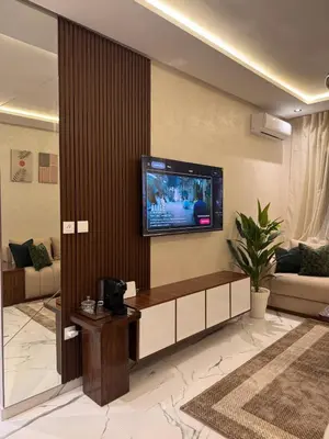 a living room with a tv on the wall at Cozy Apartment 5 min From The City Center in Fès