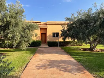 a walkway in front of a house with a tree at Olead in Aghmat