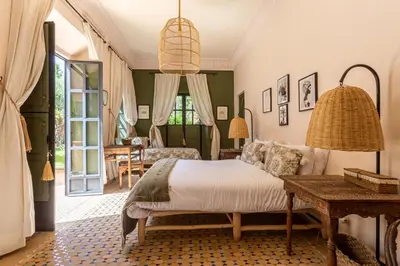 a bedroom with a bed and a table at Villa Boccara Marrakech in Chaibate