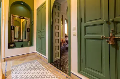 a hallway with green doors and a tile floor at Villa Boccara Marrakech in Chaibate