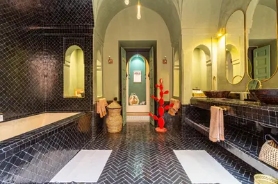 a bathroom with a blue and black tiled floor at Villa Boccara Marrakech in Chaibate