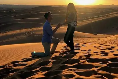 a man and a woman standing in the desert at Holiday Bivouac in Merzouga