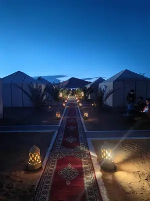 a row of lights on a train track at night at Holiday Bivouac in Merzouga