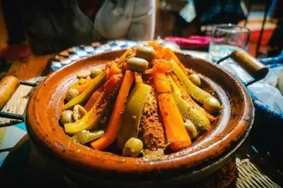 a bowl filled with vegetables on a table at Holiday Bivouac in Merzouga