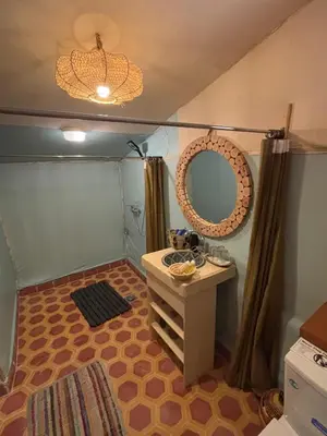 a bathroom with a sink and a mirror in a room at Desert Live Luxury Camp in Merzouga