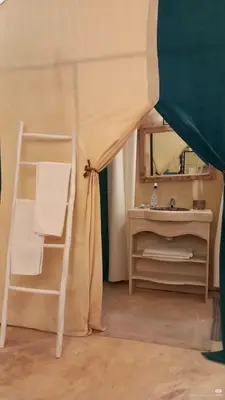 a room with a ladder and a chair and a mirror at Desert Live Luxury Camp in Merzouga