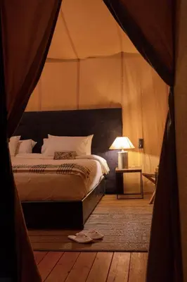 a bedroom with a bed in a tent at Desert Live Luxury Camp in Merzouga