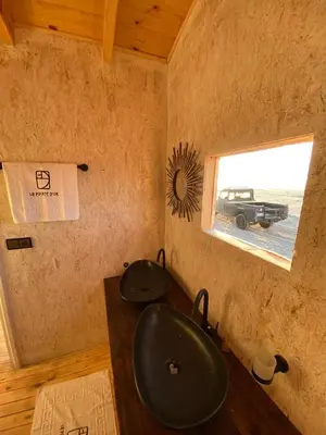 a bathroom with a sink and a window with a car at La Pointe d'Or Dakhla in Oulad Akkou