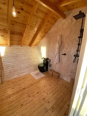 a room with a stove in a room with wooden floors at La Pointe d'Or Dakhla in Oulad Akkou