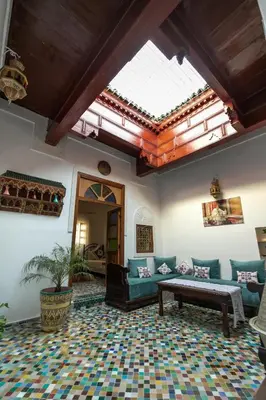 a living room with a couch and a table at Dar El Kendil in Fès
