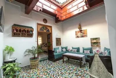 a living room with a couch and a table at Dar El Kendil in Fès