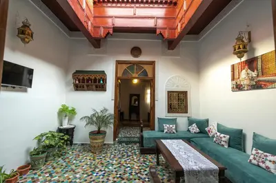 a living room with a couch and a table at Dar El Kendil in Fès