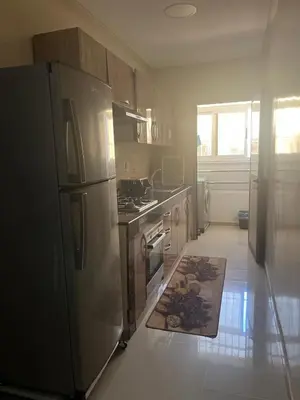 a kitchen with a stainless steel refrigerator and a stove at avenue hassan 2 agadir in Oulad Akkou