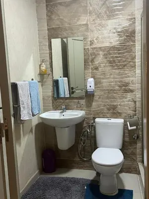 a bathroom with a white toilet and a sink at avenue hassan 2 agadir in Oulad Akkou