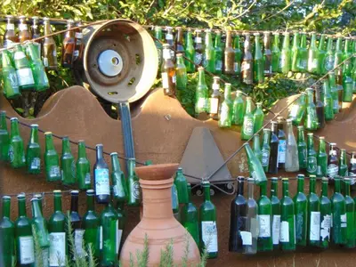 a bunch of wine bottles are lined up against a wall at Maison d'hotes Ait Bou Izryane in Timoulilt