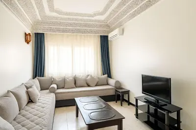 a living room with a couch and a tv at Appartement tout confort in Fès