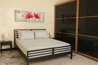 a bedroom with a bed and a painting on the wall at Appartement tout confort in Fès