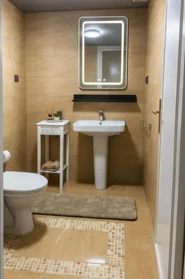 a bathroom with a sink and a toilet and a mirror at Appartement tout confort in Fès