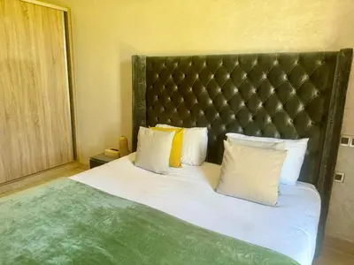 a bedroom with a large bed with white sheets and pillows at Villa de luxe à louer à la journée A Marrakech in Marrakech