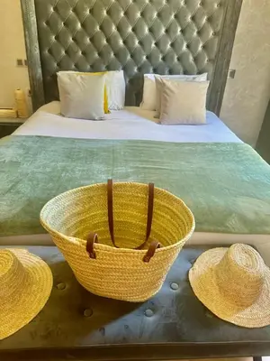 a bedroom with a bed with two straw hats at Villa de luxe à louer à la journée A Marrakech in Marrakech