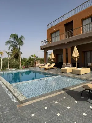 a swimming pool in front of a hotel at Luxury family villa with private pool in Douar bel Rhanodour
