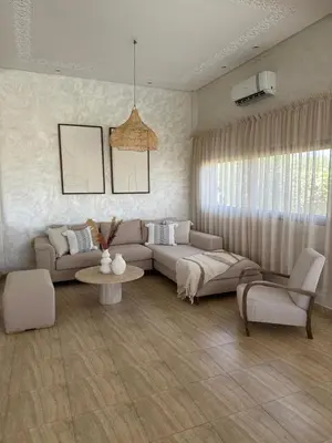 a living room with a couch and a table at Luxury family villa with private pool in Douar bel Rhanodour
