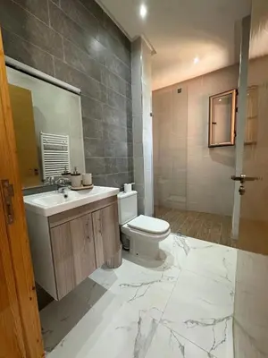 a bathroom with a toilet and a sink and a mirror at Luxury family villa with private pool in Douar bel Rhanodour
