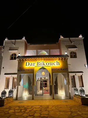 a building with a sign that reads dart blossom malayan drugs at Dar Bikouch in Aït Ben Haddou