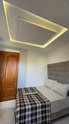 a room with a bed and a ceiling with at luxury Apartments Complete Building in Fez in Douar Trhaïtia