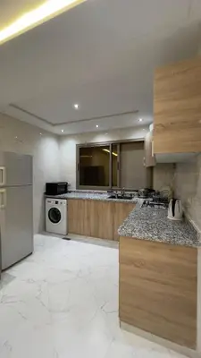 a large kitchen with a stove and a dishwasher at luxury Apartments Complete Building in Fez in Douar Trhaïtia