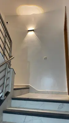 a room with stairs and a light on the wall at luxury Apartments Complete Building in Fez in Douar Trhaïtia