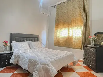a bedroom with a large bed and a window at Résidence Kawtar in Meknès