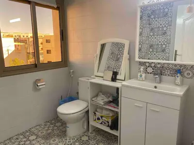 a bathroom with a toilet and a sink and a mirror at Apartment Private room in apartment in Khouribga in Khouribga