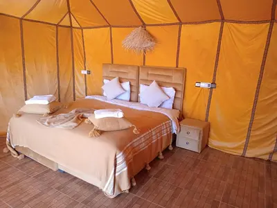 a bedroom with a bed in a tent at Good vibes desert camp in Merzouga