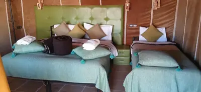 a bedroom with two twin beds with pillows at Good vibes desert camp in Merzouga