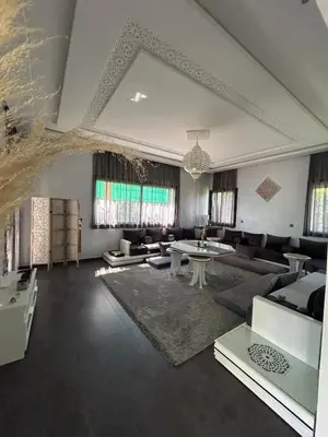 a large living room with couches and tables at Villa Prestige in Najem