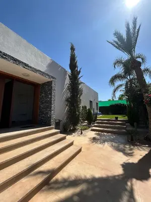 a group of stairs leading to a building with a palm tree at Villa Prestige in Najem