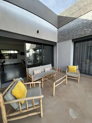 a patio with benches and chairs on a building at Villa Prestige in Najem