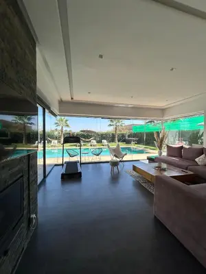 a living room with a couch and a pool at Villa Prestige in Najem