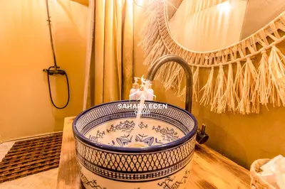 a blue and white sink in a bathroom at Sahara Eden Camp in Merzouga